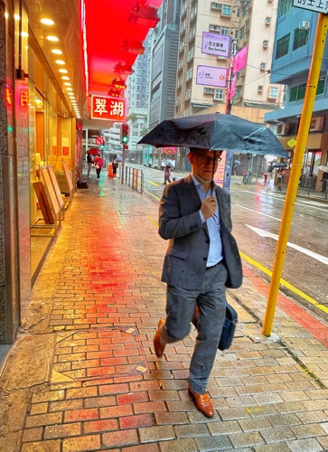 Man with umbrella in Hong Kong
